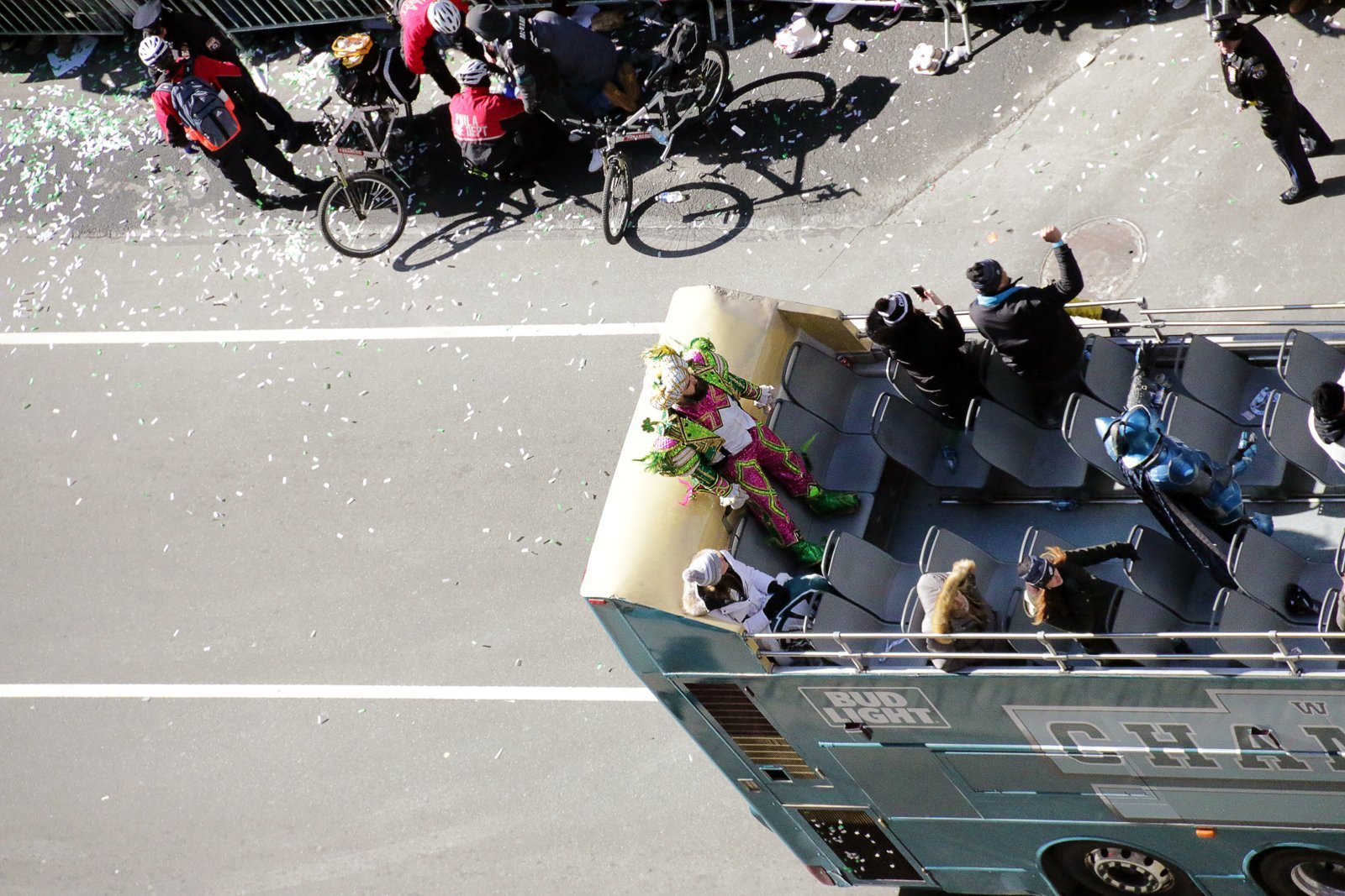 Jason Kelce in a colourful Mummers costume on top of the Eagles Super Bowl parade bus