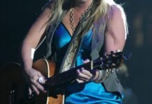 Miranda Lambert performing on stage with an acoustic guitar
