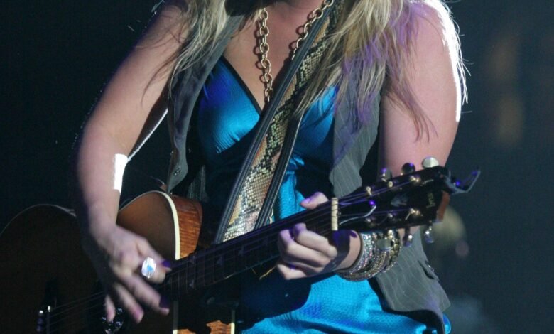 Miranda Lambert performing on stage with an acoustic guitar